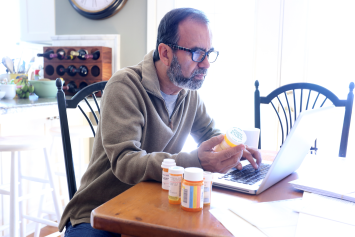 A Veteran reviewing his medication supply at home 