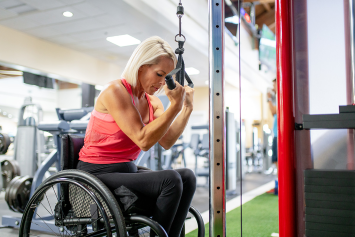 A group of older Veterans work out together in a class.