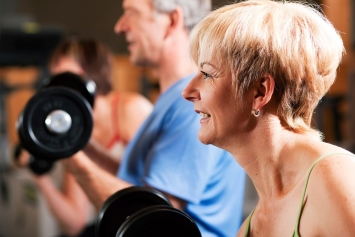 A Veteran lifts weights in a fitness class