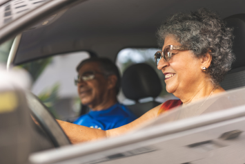 A person smiles while driving.