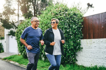 Two people jog outdoors.