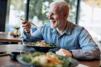 A person sits at a table and enjoys a meal.