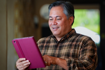 A person inputs information into a tablet.